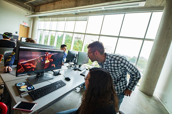 A professor and student looking at a computer screen