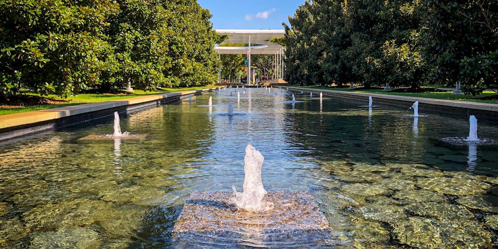 View of a reflecting pool on campus on a sunny day.