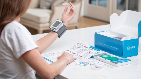 A person sitting at a desk using the virtual checkup kit.