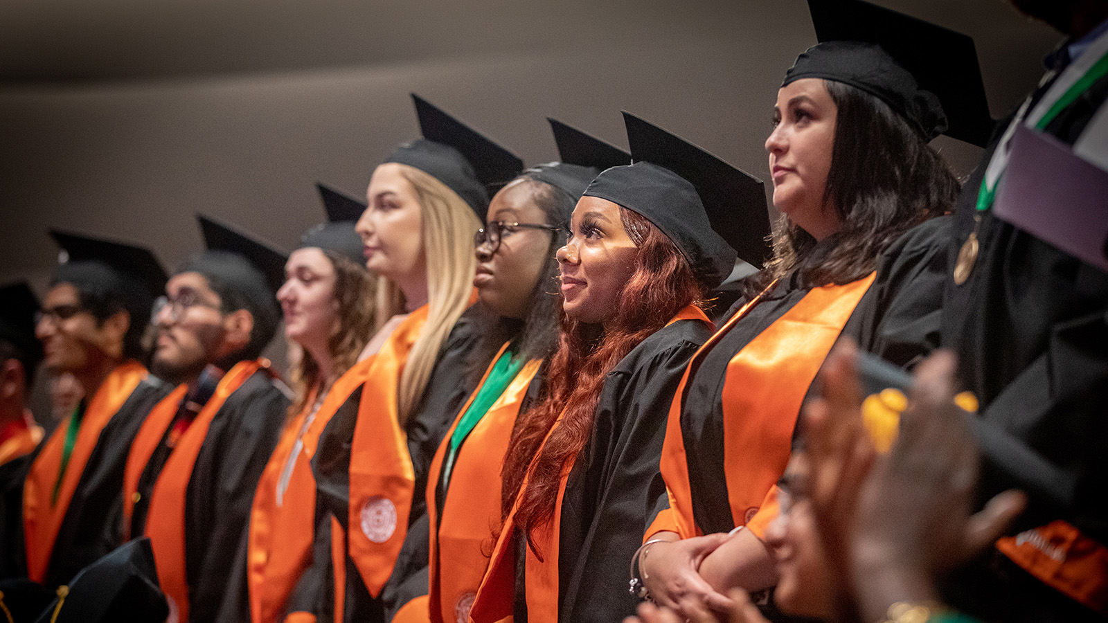 A group of students wearing regalia at commencement.