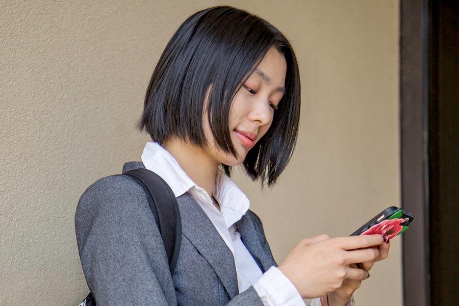 A student looks at her cellphone.