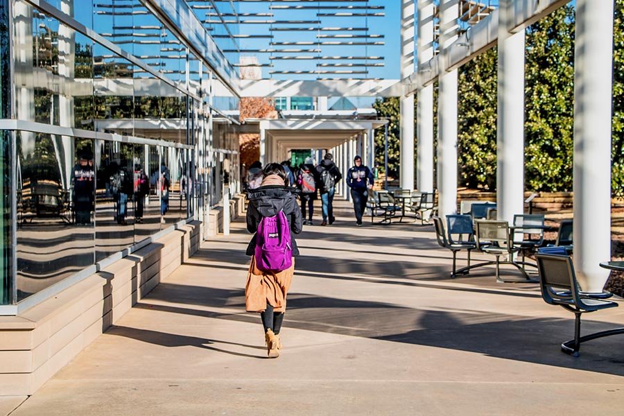 Students walk past the Student Services Building on campus.