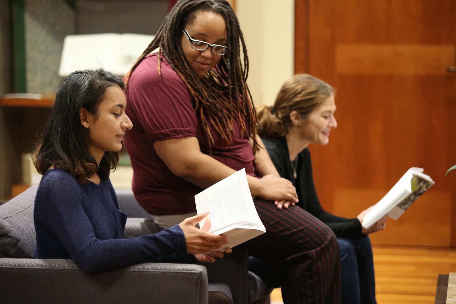 Students read while sitting on couches.