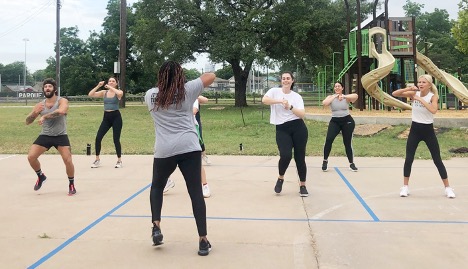 A group of people working out at a park.